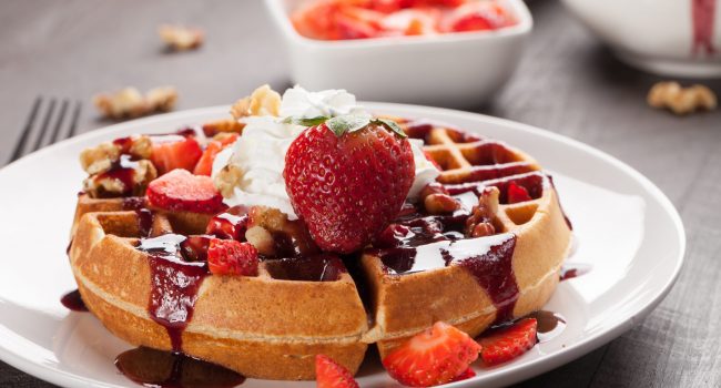 Whole,Wheat,Belgium,Waffle,Topped,With,Boysenberry,Syrup,,Whipped,Cream,